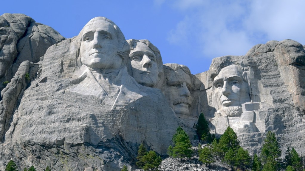 Mount Rushmore. The sculpture is carved directly into Precambrian granite along with veins of crystals of quartz and feldspar (seen here as lighter streaks across the forehead of Lincoln).