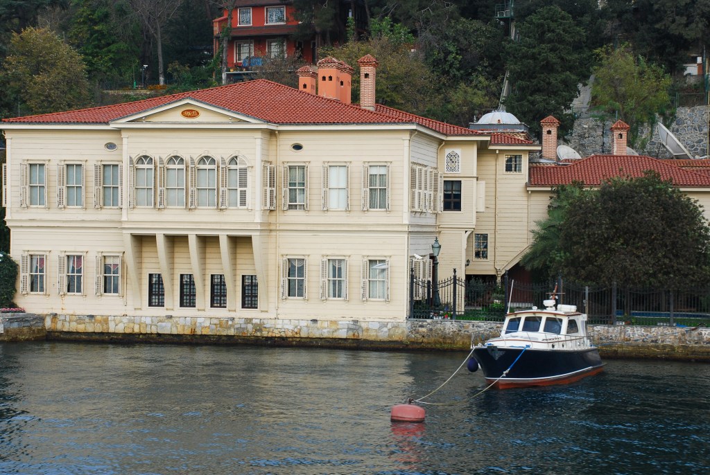 A waterfront mansion sits right at the edge of the Bosphorus, its beautiful tender rides steady on the restless tide.