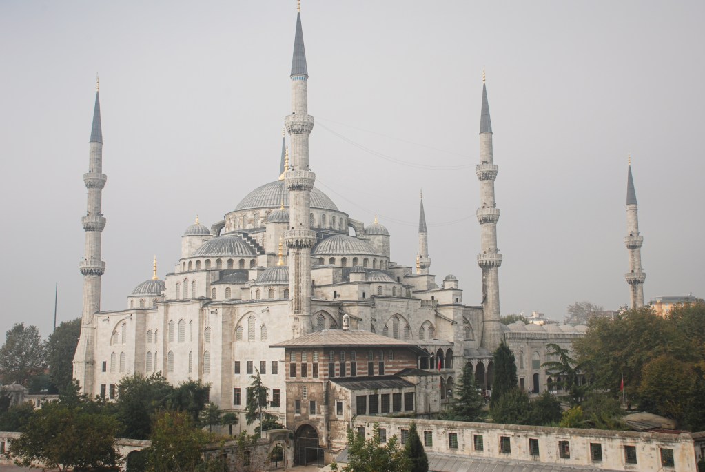 In a blush of soft morning light, the Blue Mosque stands in layered stillness
