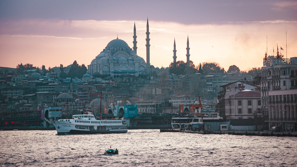 The Süleymaniye Mosque at dusk rises over Istanbul and the Golden Horn.