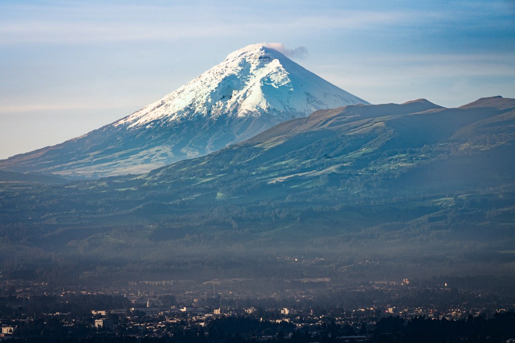 Cotopaxi rises cleanly above the patchwork fields and towns of the Cumbayá Valley, Quito.