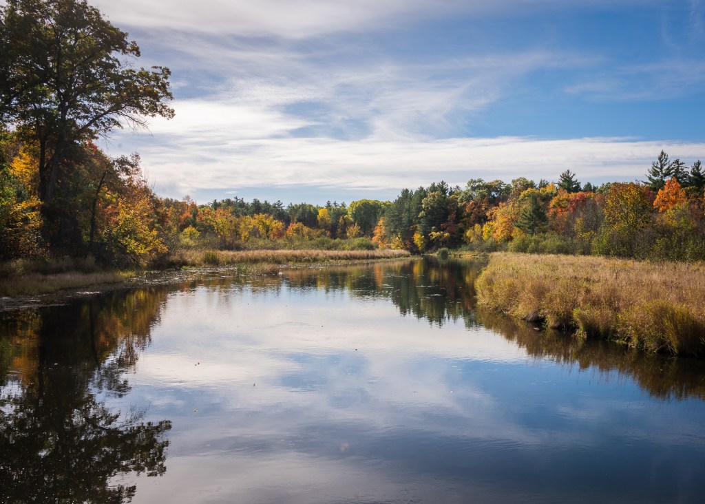 The Yellow River quietly meanders around a bend. The shores on both side embrace the river in fall colors